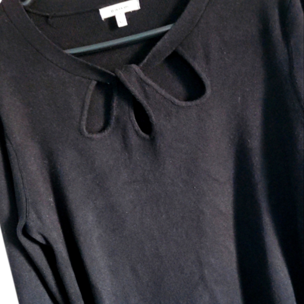Black knit light weight long-sleeved sweater with three keyhole at neck.